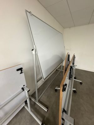 a white board on the wall in a room