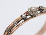 an image of a close up of a ring with pearls and diamonds