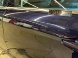 a car that has been painted blue and has a sticker on it