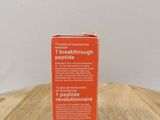 an orange box on a wooden table with a white background