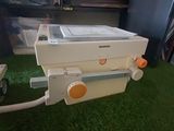 a machine that is sitting on the grass in the room