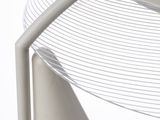 a close up of a white chair with a curved seat