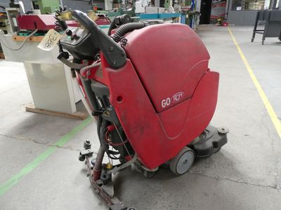 a red machine that is sitting on the floor