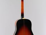 a close up of a guitar hanging from the ceiling