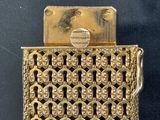 a gold purse that has a key in it