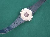 a watch that is sitting on a green surface