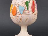 a white vase with a multicolored design on it