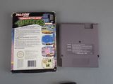 a box of nintendo games next to a game controller