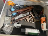 a metal box filled with assorted items on the floor