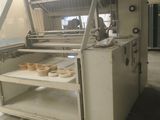 a machine that is making doughnuts in a factory