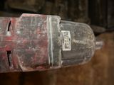 a close up of a drill with a red handle