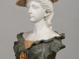 a bust of a woman wearing a hat on a table