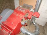 a red machine that is sitting next to a wall