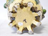 a vase that has a sunflower inside of it