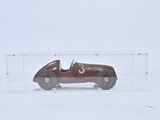 a small toy car in a clear box on a white surface