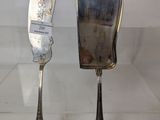 two spoons and a knife on display on a table