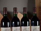 three bottles of wine are lined up on a table