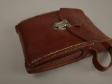 leather wallet with a metal clasp on a white surface