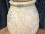 a large stone pot sitting on a wooden table