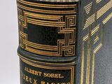 an old book sitting on top of a white table