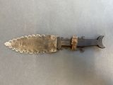 a knife that is laying on a table