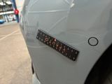 a close up of a sticker on a car ' s bumper
