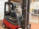 a red fork truck parked inside of a building