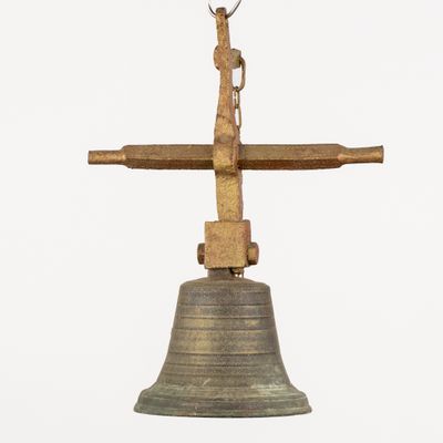 a bell with a cross on top of it on a white background