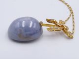 yellow gold plated necklace with a blue stone pendant and a gold plated chain