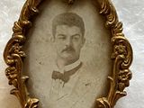 an old picture of a man in a suit and bow tie