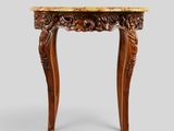 une petite table avec un plateau en marbre et des pieds sculptés