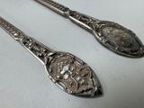 two spoons that are sitting next to each other on a table