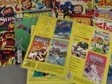 a lot of comic books that are sitting on a table
