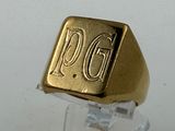 a gold signet ring with the word pgg on it