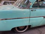 a blue car parked on the side of the street