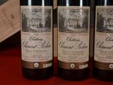 three bottles of wine that are sitting on a table