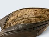 the inside of a brown purse with a zipper on it