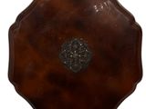 a brown vase that has a metal decoration on it