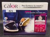 the box of a black and white steam iron is on the table