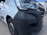 the front of a white van parked in a parking lot