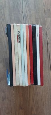 a stack of books sitting on the floor next to each other