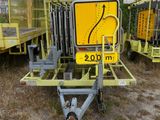 a yellow sign that is on a trailer in the dirt
