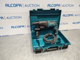 a blue tool box with a drill in it sitting on a table