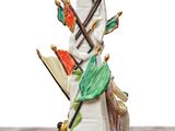 a figurine of a lighthouse with umbrellas on top of it