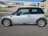 a small silver car parked in a parking lot