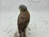 a figurine of a bird that is sitting on a table