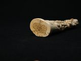 a close up of a piece of ivory with a flower on it