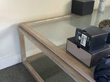 a coffee table with a glass top and a camera on top of it