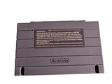 an old nintendo game console sitting on a white surface