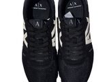 a pair of black and white sneakers on a white background
